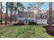 Charming two-story home with black shutters, gray siding, mature trees, and a well-manicured lawn at 1113 Harvest Mill Ct, Raleigh, NC 27610