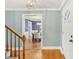View of foyer showcasing hardwood floors, neutral paint, and a view into the dining room at 1113 Harvest Mill Ct, Raleigh, NC 27610