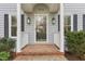 Close up of the house front door with a brick step and beautiful lanterns at 1113 Harvest Mill Ct, Raleigh, NC 27610