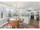 Bright eat-in kitchen featuring white cabinets, granite countertops, and stainless steel appliances at 1113 Harvest Mill Ct, Raleigh, NC 27610