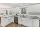 Bright kitchen featuring white cabinetry and gray granite countertops at 1113 Harvest Mill Ct, Raleigh, NC 27610