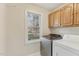 Laundry room includes stainless steel washer, dryer, and plenty of storage at 1113 Harvest Mill Ct, Raleigh, NC 27610