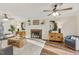 Bright and airy living room features hardwood floors, a brick fireplace, and comfortable seating at 1113 Harvest Mill Ct, Raleigh, NC 27610