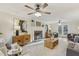 Spacious living room showcasing a fireplace, ceiling fan, wood cabinets, and stylish decor at 1113 Harvest Mill Ct, Raleigh, NC 27610