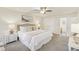 Neutral main bedroom featuring a closet, an ensuite bathroom, a ceiling fan, and carpet flooring at 1113 Harvest Mill Ct, Raleigh, NC 27610