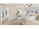 Bright bedroom featuring beige carpet, a console table, a ceiling fan, and lots of natural light at 1113 Harvest Mill Ct, Raleigh, NC 27610