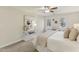 Bright main bedroom with modern ceiling fan, neutral walls, and many windows with natural light at 1113 Harvest Mill Ct, Raleigh, NC 27610