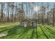 Backyard shed with ample storage, situated on a well-maintained lawn with mature trees at 1113 Harvest Mill Ct, Raleigh, NC 27610