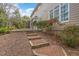 Exterior view of the backyard with a screened porch and a staircase leading to the house at 116 Galway Dr, Chapel Hill, NC 27517