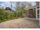 Wide backyard area showing brick patio, screened in porch and mature trees at 116 Galway Dr, Chapel Hill, NC 27517