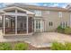 Well-maintained backyard featuring a screened-in porch and stone patio, perfect for outdoor relaxation at 116 Galway Dr, Chapel Hill, NC 27517