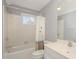 This bathroom features tile flooring, white walls, and a shower and bath with a white tile surround at 116 Galway Dr, Chapel Hill, NC 27517