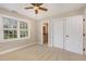 This naturally lit bedroom has carpet flooring, white trim, and a view through the window to the neighborhood at 116 Galway Dr, Chapel Hill, NC 27517