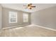 This bedroom features carpet flooring and has two windows for plenty of natural light at 116 Galway Dr, Chapel Hill, NC 27517