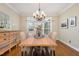 Bright dining room with a wood table, chandelier, and large window, perfect for Gathering meals and entertaining guests at 116 Galway Dr, Chapel Hill, NC 27517