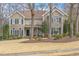 Two-story home with a well-maintained front yard, trees, and classic architectural details at 116 Galway Dr, Chapel Hill, NC 27517