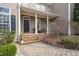 Inviting front porch with brick steps, decorative columns, and well-maintained landscaping at 116 Galway Dr, Chapel Hill, NC 27517
