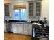 Kitchen featuring black countertops, cream cabinets, stainless steel appliances, and a window above the sink at 116 Galway Dr, Chapel Hill, NC 27517