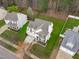 Aerial view of home with well-maintained lawn, mature trees, and inviting curb appeal at 117 Talley Ridge Dr, Holly Springs, NC 27540