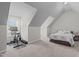 Upstairs bedroom featuring an exercise bike, tv, sloped walls and a queen bed at 117 Talley Ridge Dr, Holly Springs, NC 27540