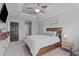 This bedroom features a tray ceiling, ceiling fan, dark interior door and a wooden bed frame at 117 Talley Ridge Dr, Holly Springs, NC 27540