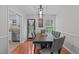 Dining room featuring rustic table, seating for six, a decorative light fixture and a view to the kitchen at 117 Talley Ridge Dr, Holly Springs, NC 27540