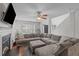 Comfortable living room with fireplace, TV, large sectional sofa, and view to the entry at 117 Talley Ridge Dr, Holly Springs, NC 27540
