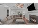 Inviting living room with a fireplace, plush sectional, and open dining area with natural light at 117 Talley Ridge Dr, Holly Springs, NC 27540