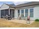 Back patio with a grill, seating area, and view of the yard, perfect for outdoor entertaining and relaxation at 1214 Gaston Manor Dr, Durham, NC 27703