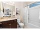 Well-lit bathroom with granite countertop, a bathtub, and vanity mirror at 1214 Gaston Manor Dr, Durham, NC 27703