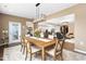 Dining room with a large wooden table, seating for six, and an open view into the kitchen at 1214 Gaston Manor Dr, Durham, NC 27703