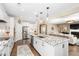 Open concept kitchen featuring an island with bar stools, granite countertops, and modern stainless steel appliances at 1214 Gaston Manor Dr, Durham, NC 27703