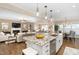 Open concept kitchen featuring granite countertops, stainless steel appliances, and an island with bar seating at 1214 Gaston Manor Dr, Durham, NC 27703
