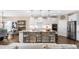 Modern kitchen featuring an island with bar seating, granite countertops, pendant lights, and stainless steel appliances at 1214 Gaston Manor Dr, Durham, NC 27703
