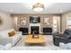 Well-decorated living room with a fireplace, modern decor, and comfortable seating arrangements at 1214 Gaston Manor Dr, Durham, NC 27703