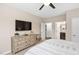 Cozy main bedroom boasts a large TV, dresser, and access to the bathroom at 1214 Gaston Manor Dr, Durham, NC 27703