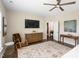 Bright main bedroom features a ceiling fan, TV and light neutral tones at 1214 Gaston Manor Dr, Durham, NC 27703