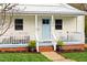 Inviting front porch with a cozy seating area and well-manicured landscaping at 1234 Berkeley St, Durham, NC 27705