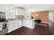 Modern kitchen leading to a dining area with stylish fixtures, stainless appliances, and wood flooring at 1234 Berkeley St, Durham, NC 27705