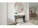Welcoming entryway with modern console table, round mirror, and stylish decor at 1244 Hardin Hill Ln, Knightdale, NC 27545
