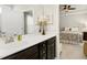 Bathroom featuring a vanity, a mirror, and a doorway view into the primary bedroom at 1407 Palmer Hill Dr, Durham, NC 27703