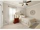 Bright bedroom with a window, ceiling fan, and a cozy bed with decorative pillows at 1407 Palmer Hill Dr, Durham, NC 27703
