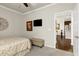 Bedroom featuring a ceiling fan, an ottoman, and a view into a hallway and kitchen at 1407 Palmer Hill Dr, Durham, NC 27703