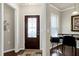 Welcoming entryway with a decorative front door, stylish rug, and adjacent office space at 1407 Palmer Hill Dr, Durham, NC 27703