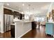 Open-concept kitchen flowing into the living area, featuring granite countertops and modern fixtures at 1407 Palmer Hill Dr, Durham, NC 27703