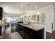 Kitchen featuring dark cabinets, granite counters, and an open view to the dining and living areas at 1407 Palmer Hill Dr, Durham, NC 27703
