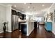 Modern kitchen with stainless steel appliances, dark cabinets, and a spacious center island at 1407 Palmer Hill Dr, Durham, NC 27703