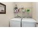 Well-equipped laundry room featuring modern washer and dryer with ample shelving for storage at 1407 Palmer Hill Dr, Durham, NC 27703