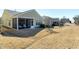 A wide view of a home with a screened porch, seating, and well-maintained lawn and landscaping at 1407 Palmer Hill Dr, Durham, NC 27703