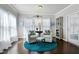 Sitting room with two accent chairs, side table, and a round blue area rug near bright windows at 1407 Palmer Hill Dr, Durham, NC 27703